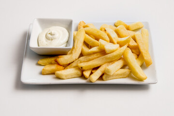 A plate of french fries on a white background