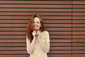 Happy woman laughing as she plays with her hair