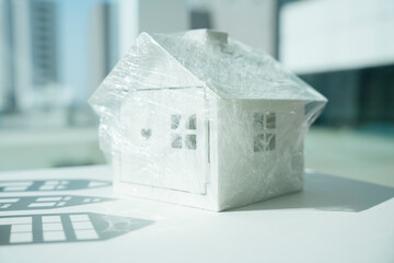 A white house wrapped with plastic wrap preventing covid-19.