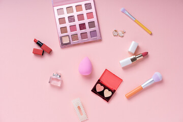 Cosmetic pink collection set on bright pink background.