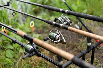 Fototapeta na wymiar fishing rod with reel. Carp fishing rods on rod pod isolated.