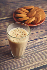 Cup of Tea on wooden table with Butter biscuits