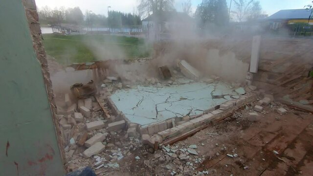 Brick Wall Collapses During Demolition Of An Old Building. Slow Motion Footage