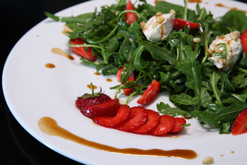 Salad with arugula, cream cheese and strawberries. Salad with arugula and strawberries. Rucola and strawberries.