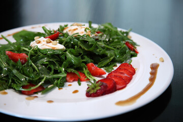 Salad with arugula, cream cheese and strawberries. Salad with arugula and strawberries. Rucola and strawberries.