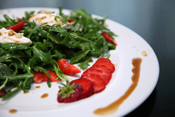 Salad with arugula, cream cheese and strawberries. Salad with arugula and strawberries. Rucola and strawberries.