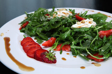 Salad with arugula, cream cheese and strawberries. Salad with arugula and strawberries. Rucola and strawberries.