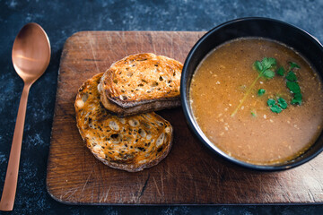 plant-based food, vegan potato and leek soup with coriander and bread