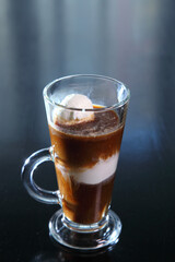 Ice cream coffee with a glass goblet with a pen.