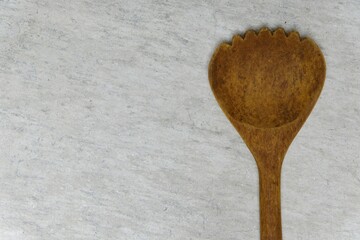 hand holding a wooden ladle