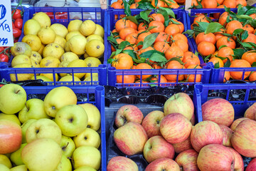Apples and clementines for sale at a market