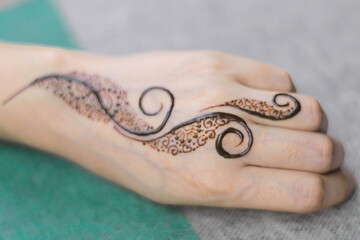Woman Hands with black mehndi tattoo. Hands of Indian bride girl with black henna tattoos. Hand...
