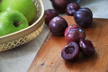 Close up Juicy Fresh Plum on Wooden Board