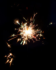 Lighting a Firework Sparkler In Celebration of the Holidays Crackling in the Dark