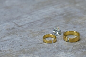 wedding rings on a concrete background