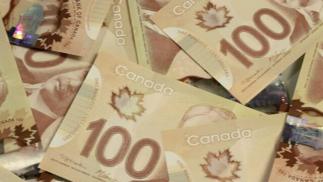 Many Canadian $100 bills, polymer plastic type.