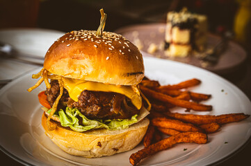 big pork hamburger on a plate on a wooden table