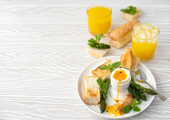 breakfast with poached egg, asparagus and toasted bread
