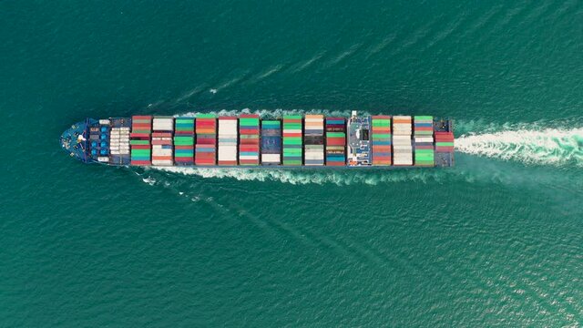 Vedio Container ship in export and import business and logistics. Shipping cargo to harbor by crane. Water transport International. Aerial view and top view.