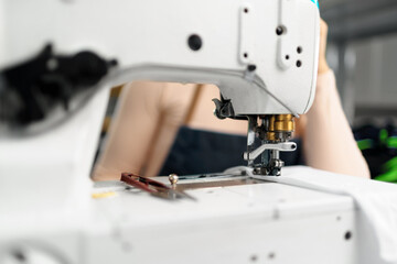 Close up of a seamstress with a sewing machine