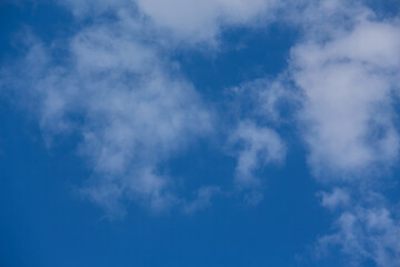 Obraz premium Beautiful blue sky with fluffy clouds. The concept of dreaminess and lightness. Meteorology and atmospheric phenomena. Different types of clouds. Layered clouds.