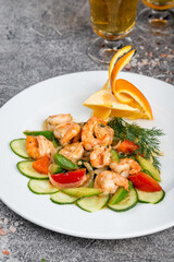 Tiger prawns with vegetables on a white plate
