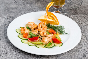 Tiger prawns with vegetables on a white plate