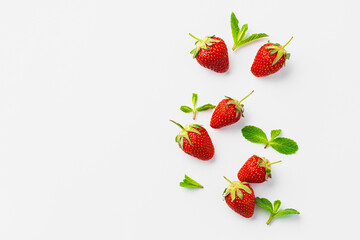 Top view of fresh strawberries with leaves on white background