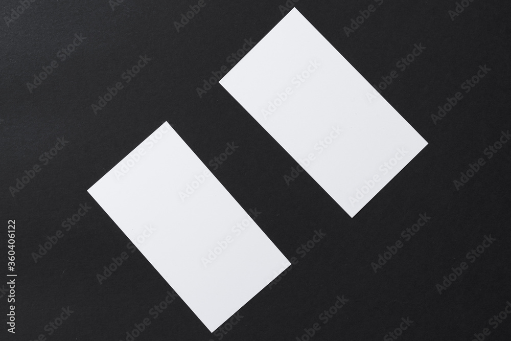 Wall mural White blank business cards on dark black background