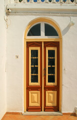 Fototapeta na wymiar Door of a monk`s cell at the Monastery of Archangel Michael Panormitis, Symi island, Greece
