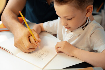 Little boy writing something in his notebook © fotofabrika