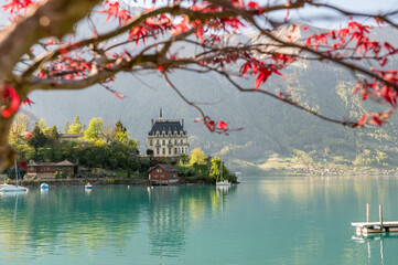 view of Schloss Seeburg, Iseltwald in turquoise Lake Brienz