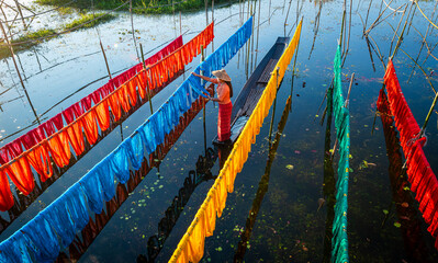 Intha people working with handcrafted colorful lotus fabrics in inle lake is life style of intha...