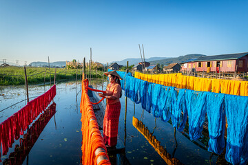 Intha people working with handcrafted colorful lotus fabrics in inle lake is life style of intha...