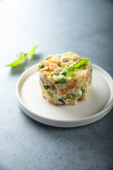 Traditional homemade Olivier salad on a white plate
