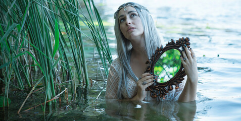 Old European magic, Mystical Pagan scene, woman in lake, rituals. Magic divination in water,...