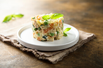 Traditional homemade Olivier salad on a white plate