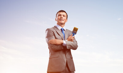 Creative businessman painter holding paintbrush