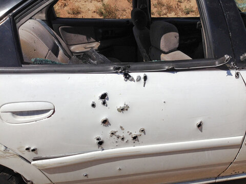 Automobile shot up bullet gun fire fight holes