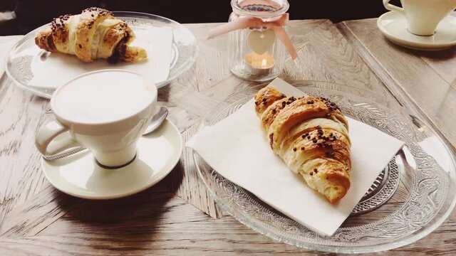 Cappuccino and chocolate croissant in cafe, cup of coffee and pastry dessert for breakfast, food and baked goods close-up