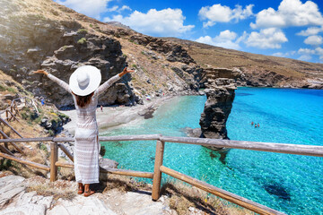 Eine Touristin in weißem Kleid genießt den Ausblick auf den berühmten Strand Tis Grias To Pidima...