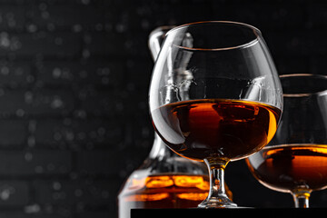 Whisky glass against dark black grunge wall