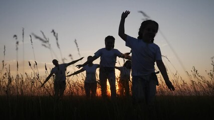 dream future concept. children kid run happy family concept at sunset silhouette. hands on hand play aviator pilot show airplane. people in the park parents mom and dad children daughter lifestyle