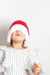 Portrait of toddler girl in red hat on Christmas. Surprise concept
