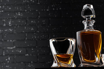 Whisky glass against dark black grunge wall
