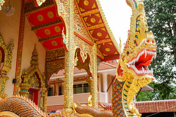 Chiang Rai, THAILAND , Wat Phra Kaew, carved golden dragon at the entrance to the pagoda, protector