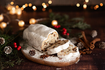 Traditional German Christmas cake - Cranberry Stollen, Christmas tree, ornaments, and candles.