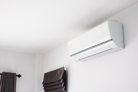 Air conditioner on white wall room interior background