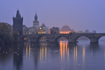 Fototapeta na wymiar Charles Bridge in Prague Old Town on Vltava River. Bridge Tower. Early morning. Heavy fog.