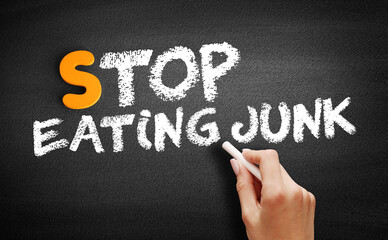 Stop Eating Junk text on blackboard, concept background